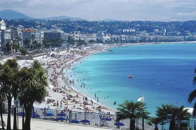 a beach with a lot of people in the water at Old Town Luxury 3 Beds in Nice