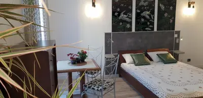 a small bedroom with a bed and a table at Studio Lou Nidou, Nice Centre in Nice