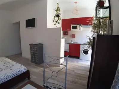 a room with a kitchen with red and white at Studio Lou Nidou, Nice Centre in Nice
