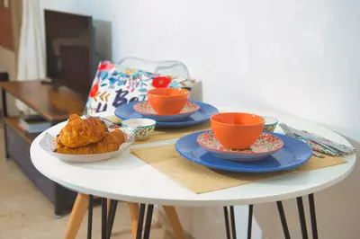 a table with plates of food and cups on it at BEACH FLAT in Nice