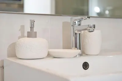 a bathroom sink with a faucet and two dishes at BEACH FLAT in Nice