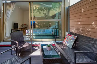 a screened in porch with two chairs and a table at BEACH FLAT in Nice