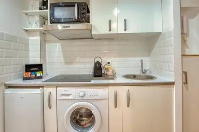 a small kitchen with a washing machine and a sink at BEACH FLAT in Nice