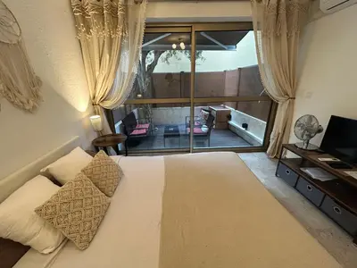 a bedroom with a bed and a large window at BEACH FLAT in Nice