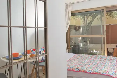 a room with a bed and a table and a window at BEACH FLAT in Nice