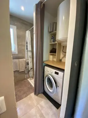 a laundry room with a washing machine in a bathroom at STUDIO pied village EZE - dans VILLA - Parking Gratuit in Èze