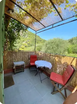 a patio with two chairs and a table and a table at STUDIO pied village EZE - dans VILLA - Parking Gratuit in Èze