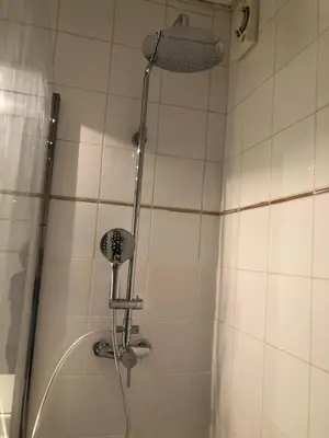 a shower with a shower head in a bathroom at Villa C3 Arthur Rimbaub chambre d’hôte piscine proche mer plage 600m in Cagnes-sur-Mer