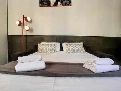 a bed with two pillows on top of it at Nestor&Jeeves - RED TOUCH - Central - Close sea in Nice