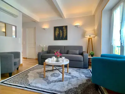 a living room with a couch and a table at Palais Massena - Easy Home Booking in Nice