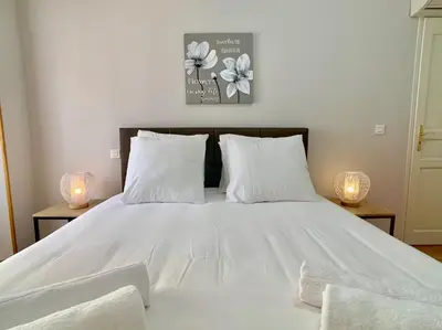 a bedroom with a white bed with two lamps at Palais Massena - Easy Home Booking in Nice
