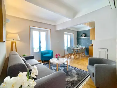 a living room with a couch and a table at Palais Massena - Easy Home Booking in Nice
