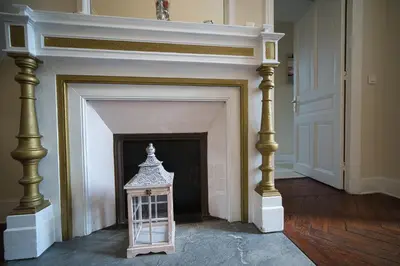 a fireplace with a lantern in a living room at Prestige Designer Apartment, Super Central in Nice