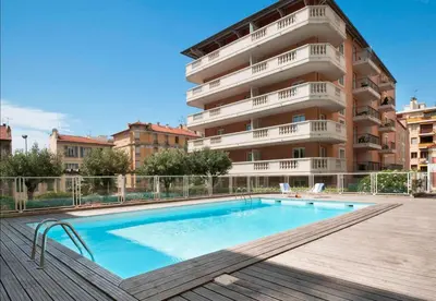 a swimming pool in front of a building at Domes Seaside Résidence Piscine, Free Parking, Airport Tramway in Nice