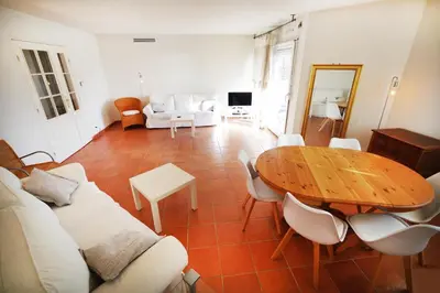 a living room with a wooden table and chairs at Domes Seaside Résidence Piscine, Free Parking, Airport Tramway in Nice
