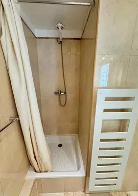 a bathroom with a shower with a shower curtain at Cosy Cocoon Place Massena in Nice
