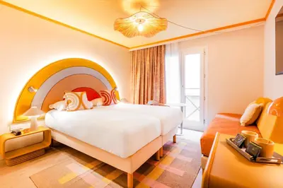 a hotel room with a large bed and a couch at Nice Pam Hotel in Nice