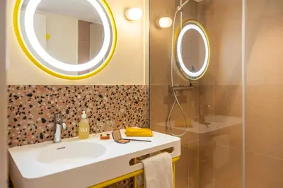 a bathroom with a sink and a mirror at Nice Pam Hotel in Nice