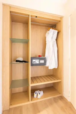 a cupboard with a dress and a box in it at Nice Pam Hotel in Nice