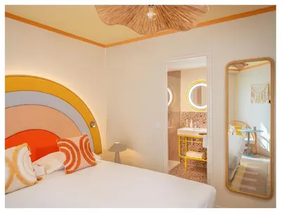 a bedroom with a large bed and a mirror at Nice Pam Hotel in Nice