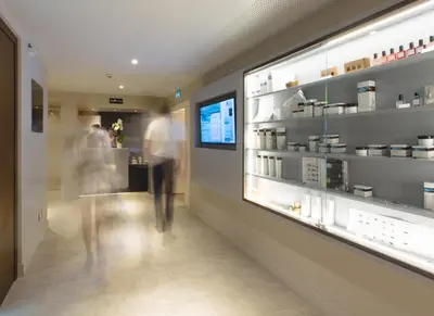 a shop with a man walking past a counter at Les Terrasses d'Eze - Hôtel & Spa in Èze