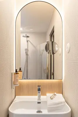 a bathroom with a sink and a large mirror at Albert 1er in Nice