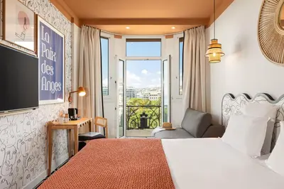 a hotel room with a bed and a balcony at Albert 1er in Nice