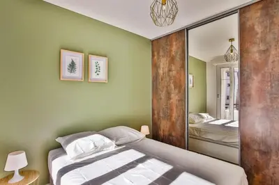 a bedroom with a bed and a mirror at Rossini Centre Ville - Proche Tram in Nice