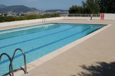 a large swimming pool with blue water at Studio Le Fabrina Riviera in Nice
