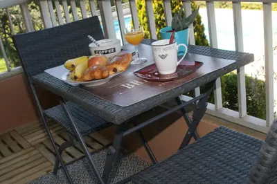 a table with a plate of bread and drinks on a balcony at Studio Le Fabrina Riviera in Nice