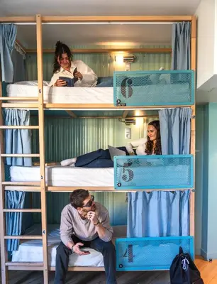 a group of people sitting on bunk beds at Hostel Ozz Nice in Nice