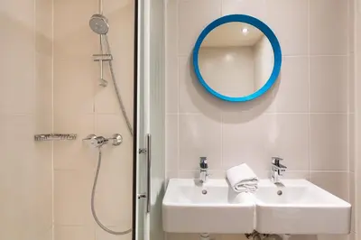 a bathroom with a sink and a mirror at Hostel Ozz Nice in Nice