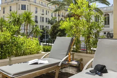 a pair of chairs sitting on a balcony at Best Western Plus Hôtel Brice Garden Nice in Nice