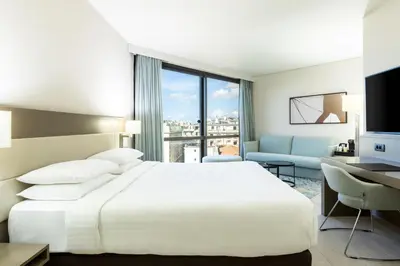 a bedroom with a white bed and a large window at AC Hotel by Marriott Nice in Nice