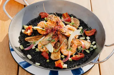a pan full of food with shrimp and vegetables at AC Hotel by Marriott Nice in Nice