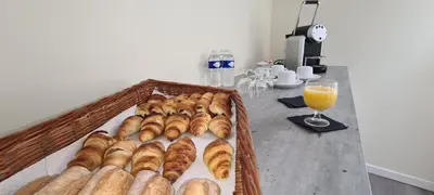 a tray of croissants and a glass of orange juice at Hôtel Le Seize, Nice Centre in Nice