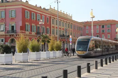 a tram on a city street with buildings at Hôtel Le Seize, Nice Centre in Nice