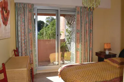 a bedroom with a bed and a large window at AZURELLE in Nice