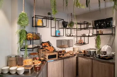 a kitchen with lots of food on a counter at Best Western Plus Nice Cosy Hotel in Nice