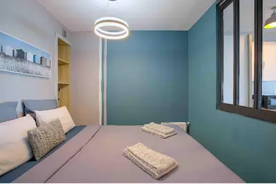 a bedroom with a large bed with two pillows at Flat design with SEA view promenade des anglais in Nice