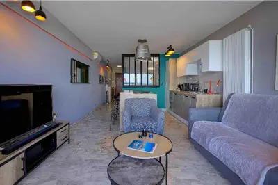 a living room with a couch and a table at Flat design with SEA view promenade des anglais in Nice