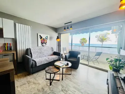 a living room with a couch and a view of the ocean at Flat design with SEA view promenade des anglais in Nice