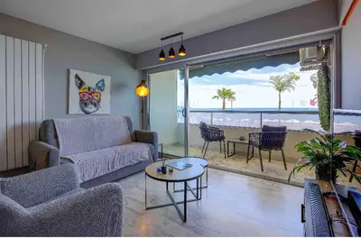 a living room with a couch and a table at Flat design with SEA view promenade des anglais in Nice