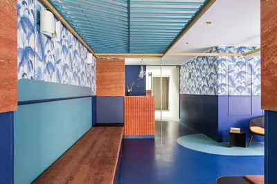 a hallway with blue and purple walls in a building at Hôtel les Cigales in Nice