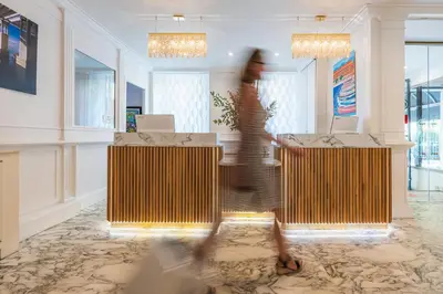 a person walking through a room with two podiums at Hotel Villa Victoria in Nice