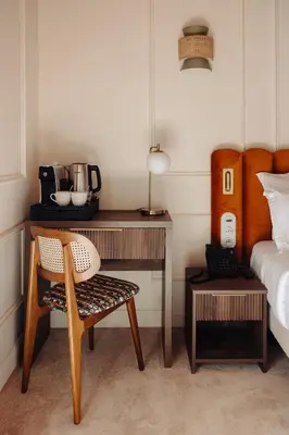 a bedroom with a desk with a chair and a bed at Hotel Ambassador, completely renovated in Nice