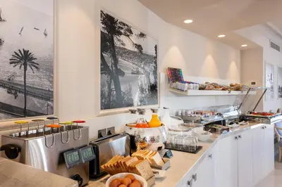 a kitchen with a counter with food on it at Hotel Suisse in Nice