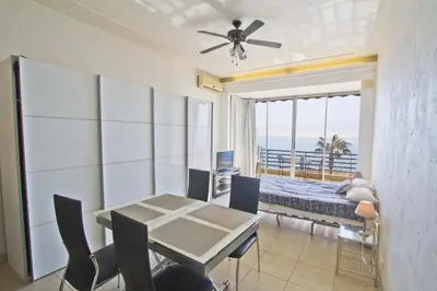 a dining room with a table and a view of the ocean at LES MOUETTES - PROMENADE HOLIDAY in Nice