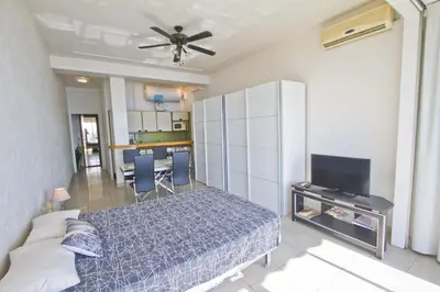 a bedroom with a bed and a ceiling fan at LES MOUETTES - PROMENADE HOLIDAY in Nice