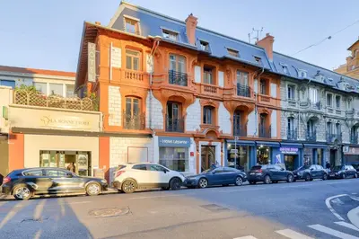 a row of cars parked in front of a building at Hotel Lepante in Nice